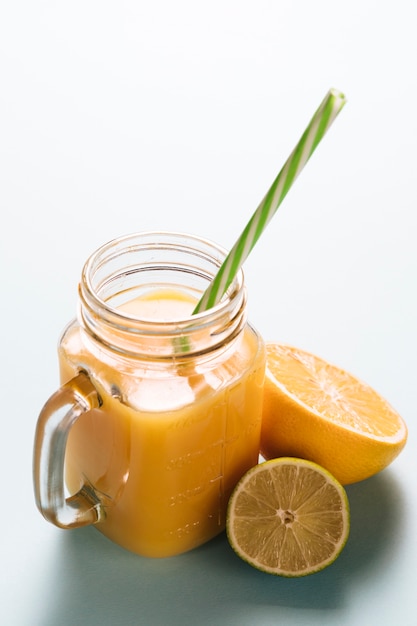 Glass of lemonade on plain background