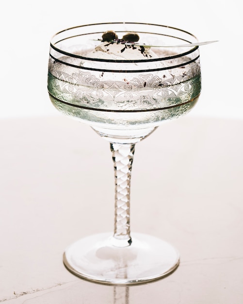 A glass of martini in white background.