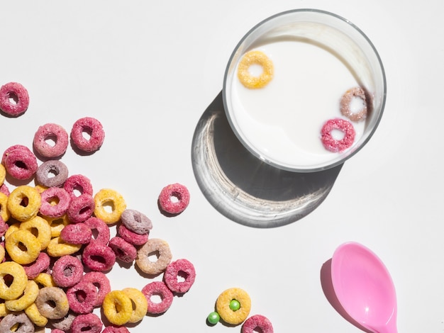 Free photo glass of milk and cereal on white background