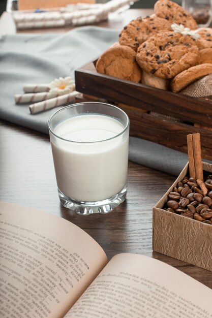 A glass of milk with biscuits