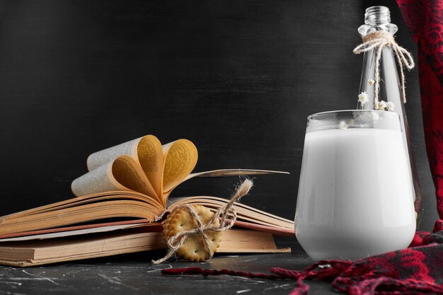 A glass of milk with cookies. 