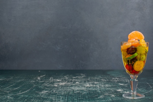 Free Photo glass of mixed fruits on marble table.