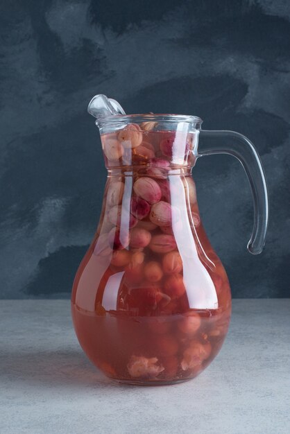 A glass pitcher with juice on dark background. High quality photo