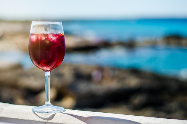 Free Photo glass of sangria by a sea bar