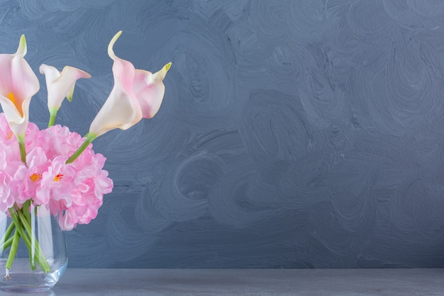 A glass vase with bouquet of pink beautiful fresh flowers.