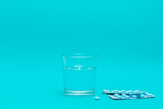 Glass of water and pills