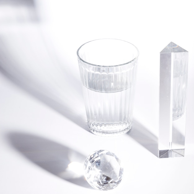 Glass of water; prism; sparkling diamond on white background