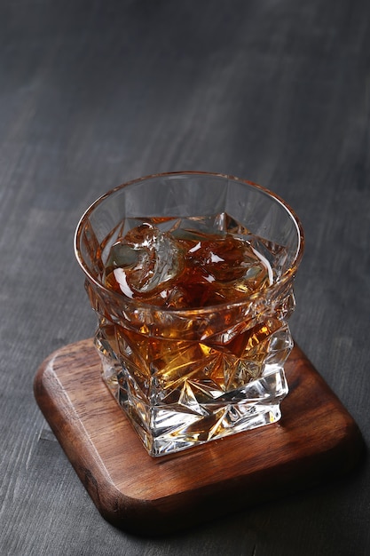 Free photo glass of whiskey or bourbon, only with ice