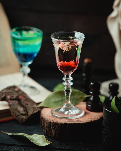 glass with alcohol beverage on the table