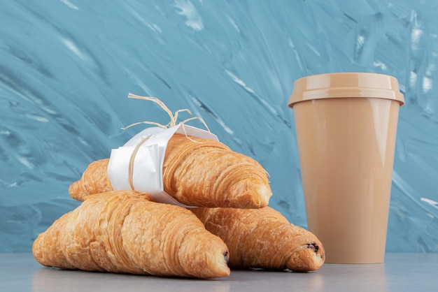 Glass with croissants on the marble background. High quality photo