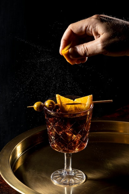 Glass with fruity drink on tray