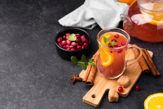 Glass with fruity flavor tea on wooden board