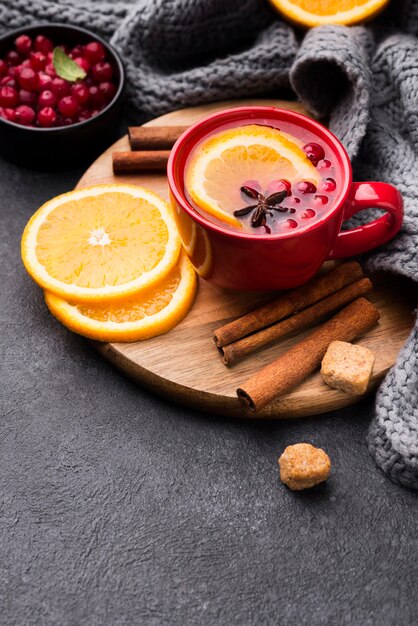 Glass with fruity flavor tea on wooden board