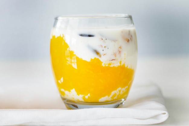 Glass with yogurt on piece of cloth