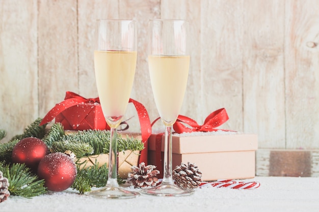 Glasses of champagne with gifts and christmas decorations