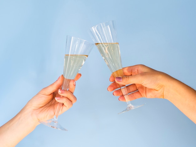 Free photo glasses filled with champagne toasting