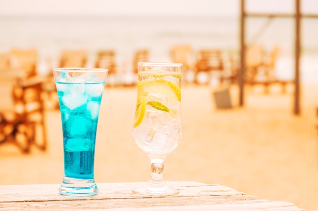 Free Photo glasses of fresh blue mint drinks at wooden table