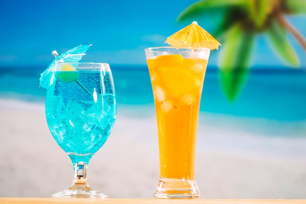 Glasses of fresh blue orange drink decorated with olive and umbrella