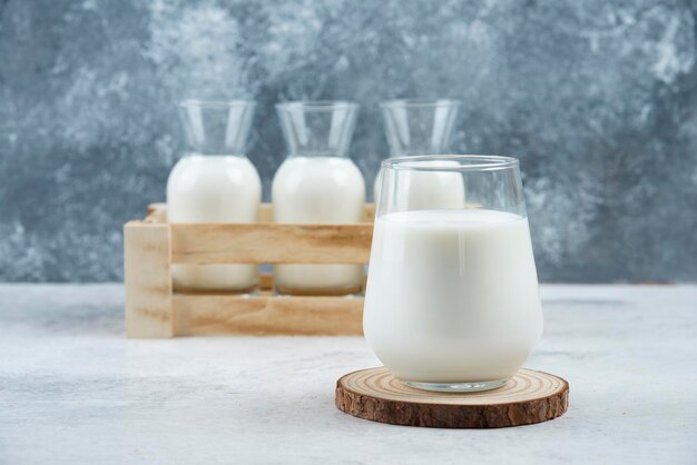 A glasses of milk on a gray table.