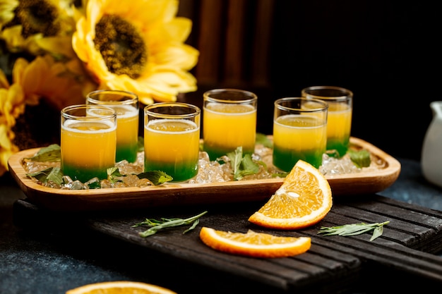 Free photo glasses of ombre juice with mint and orange