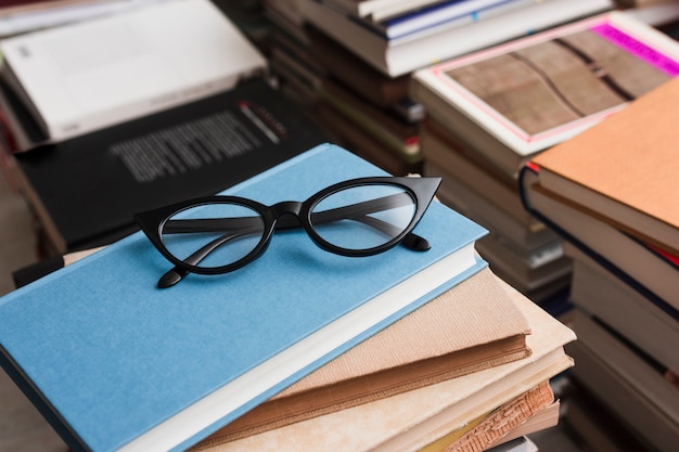 Free photo glasses on pile of books