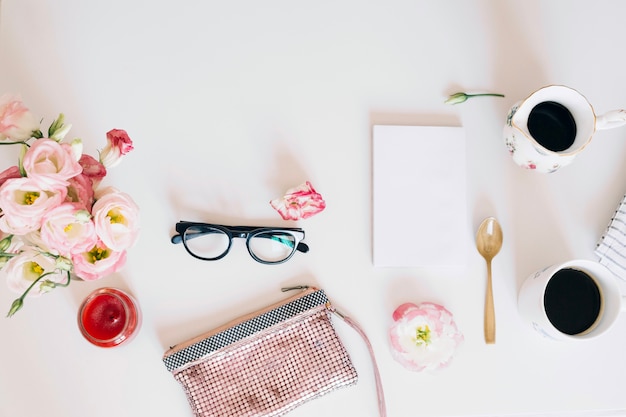 Glasses and purse near coffee cups