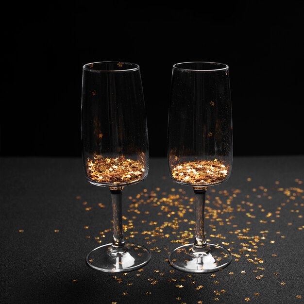 Glasses with bright spangles on table