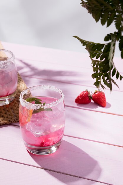 Glasses with cold strawberry drink on table