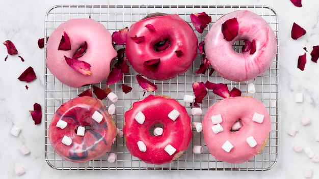 Free Photo glazed donuts with rose petals