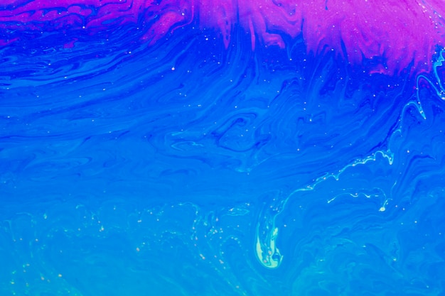 Gleaming wavy blue and purple abstract background