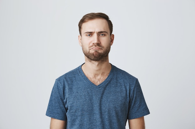 Free photo gloomy grumpy bearded guy look disappointed