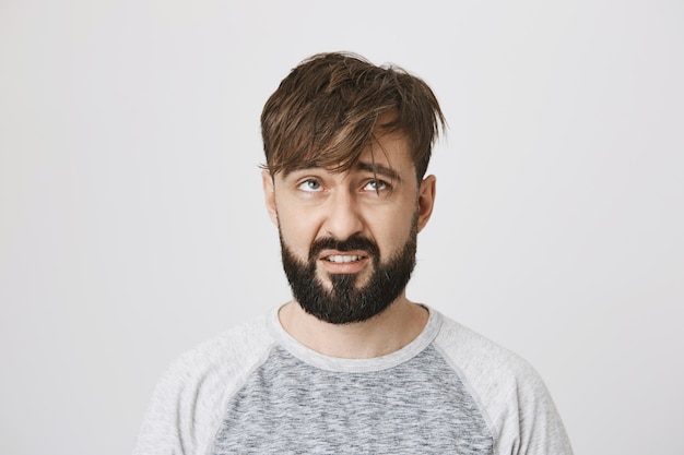 Free photo gloomy messy bearded guy with tossed hair