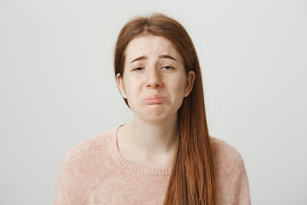 Gloomy whining redhead girl sobbing and pouting reluctant