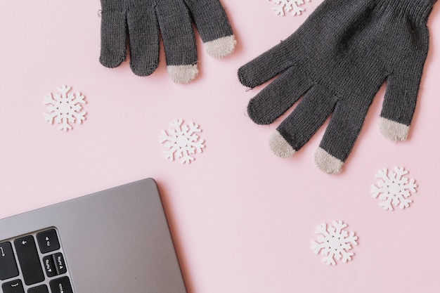 Free Photo gloves with small snowflake on table 