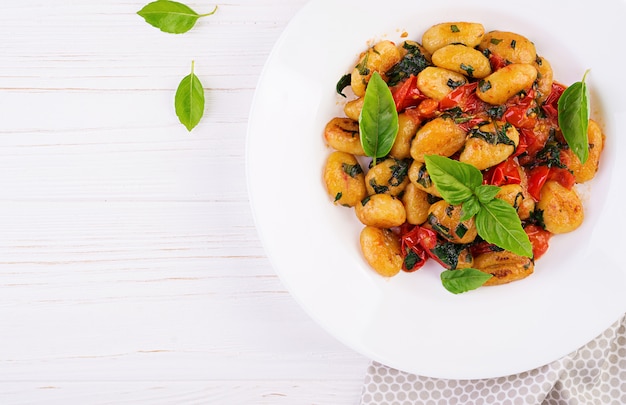 Gnocchi pasta in rustic style.  Italian cuisine. Vegetarian vegetable pasta. Cooking lunch. Gourmet dish. Top view