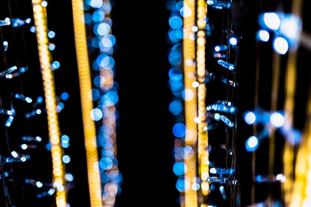 Free photo gold and blue abstract bokeh black background