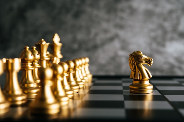 Gold Chess on chess board game for business metaphor leadership concept