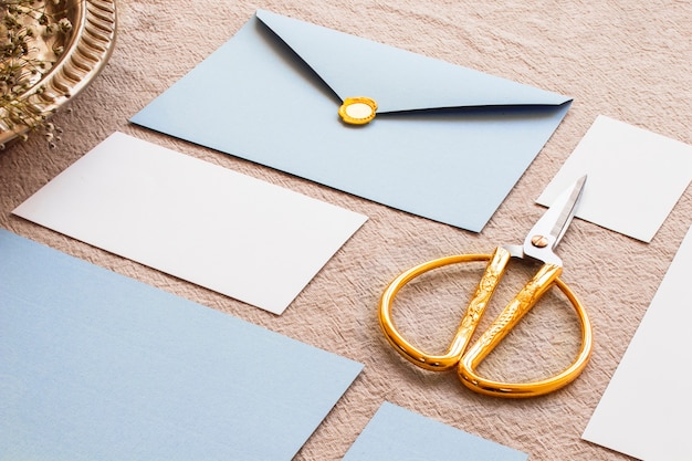 Gold scissors in composition on tablecloth