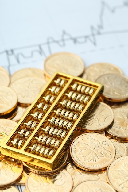 Free photo golden abacus with chinese rmb gold coins as background