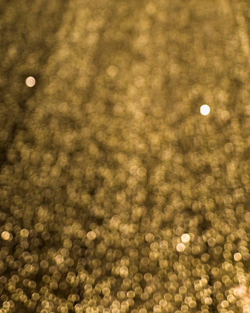 Free photo golden blurred illuminated bokeh backdrop