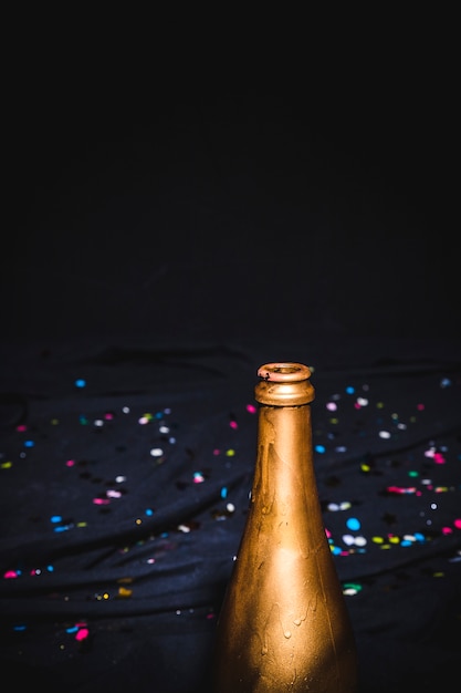 Golden bottleneck with confetti