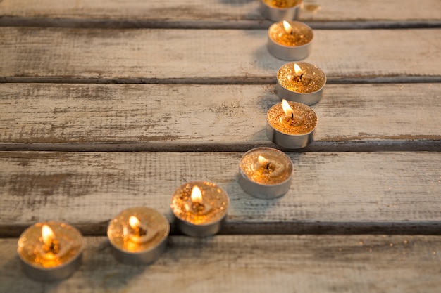 Free Photo golden candles lit up in a circle