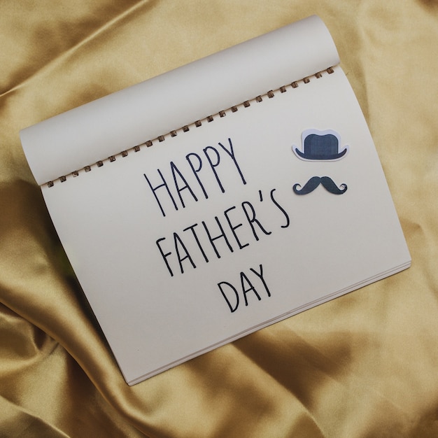 Free photo golden canvas with notebook for father's day