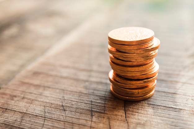 Golden coins on wooden board