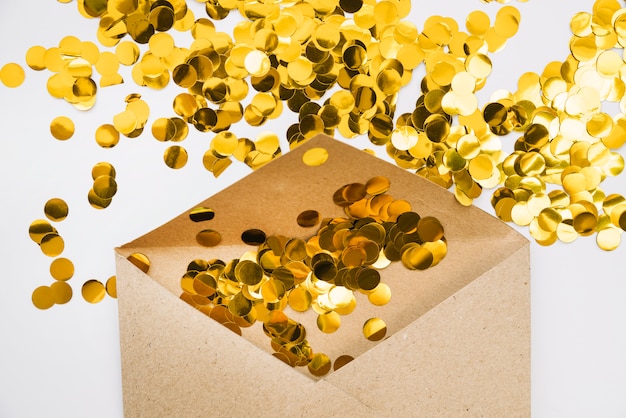 Golden confetti in paper envelope