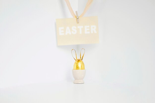 Free photo golden egg and easter word