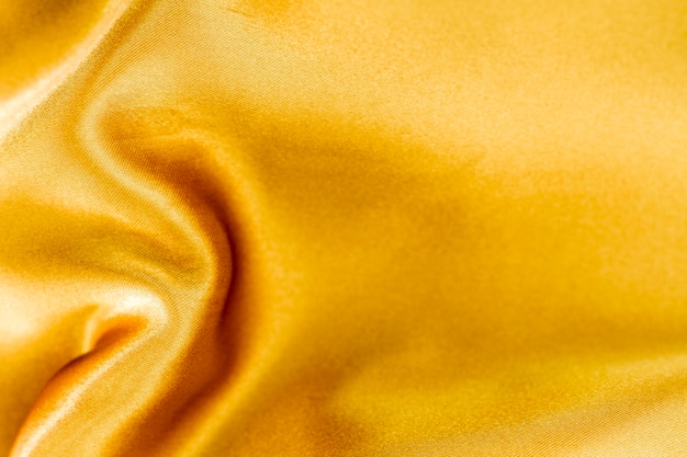 Free photo golden fabric material texture with copy space