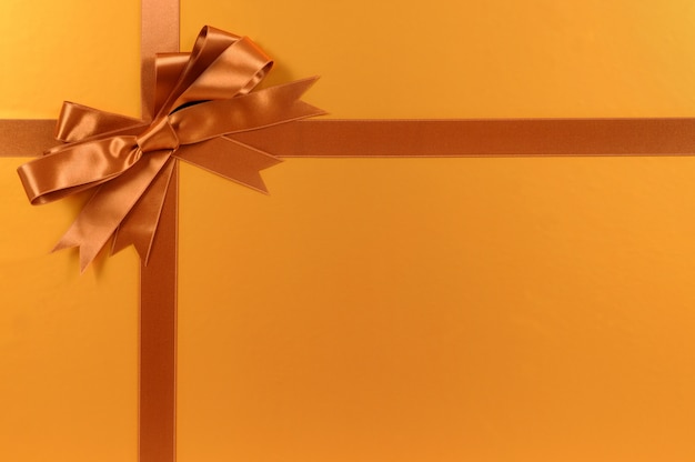 Free photo golden gift with elegant bow