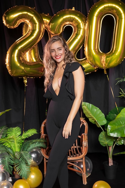 Golden new year 2020 balloons and beautiful girl