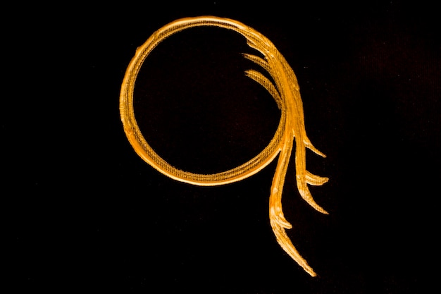 Golden painted circle on black background